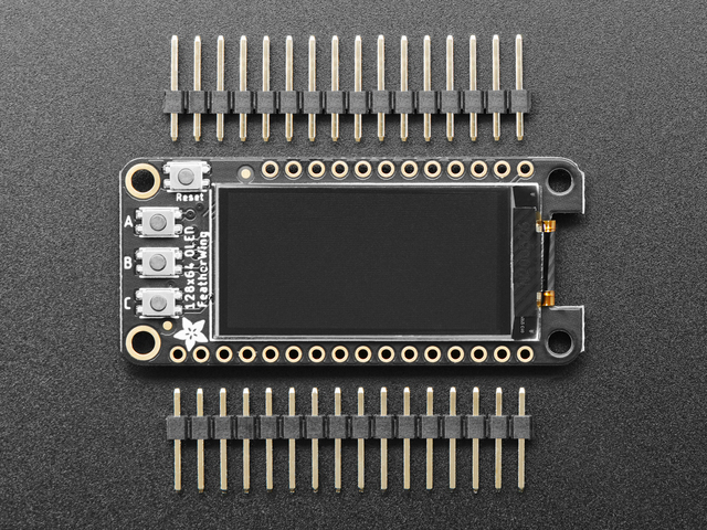 The 128×64 OLED FeatherWing between two loose header strips: its dark display, a Reset button and buttons A, B and C.